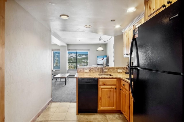 kitchen with sink, pendant lighting, light colored carpet, light stone countertops, and black appliances