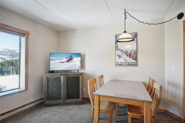 carpeted dining area featuring a baseboard radiator