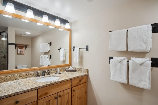 bathroom featuring vanity and toilet