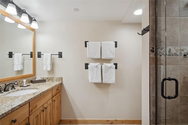 bathroom featuring vanity and a shower with door