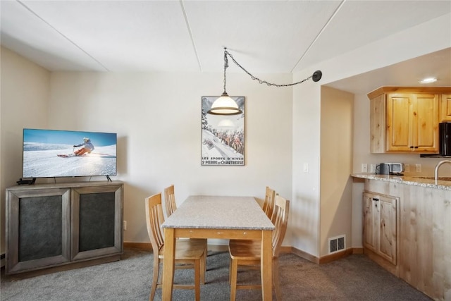 carpeted dining space featuring sink