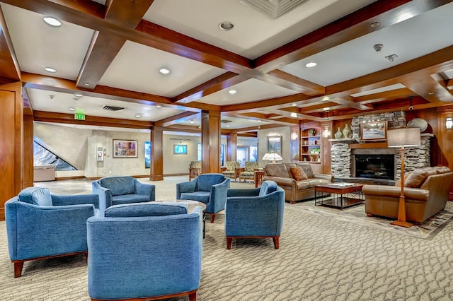 living room featuring coffered ceiling, a stone fireplace, built in features, light colored carpet, and beam ceiling