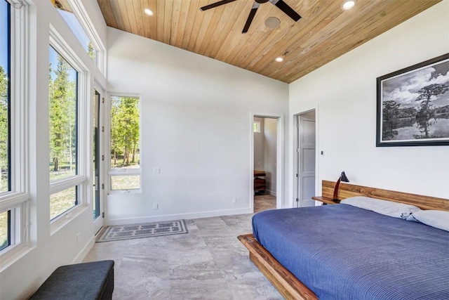 bedroom with ceiling fan, wood ceiling, ensuite bathroom, and vaulted ceiling