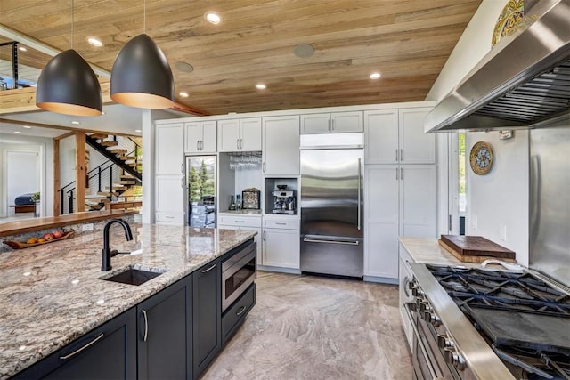 kitchen with built in appliances, white cabinetry, wall chimney exhaust hood, and wood ceiling