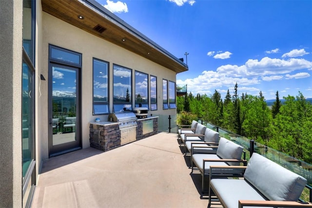 view of patio / terrace featuring an outdoor living space, area for grilling, and a grill