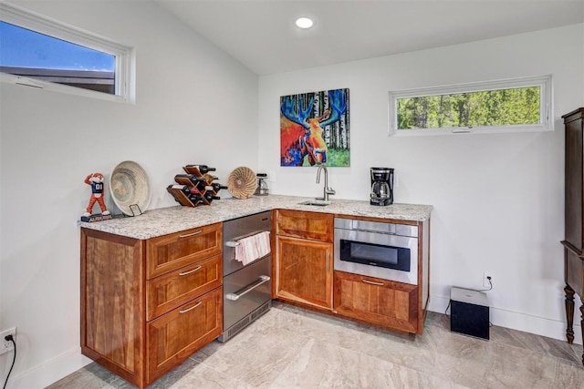 kitchen with light stone counters and sink