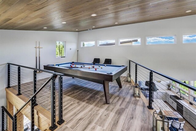 recreation room with light wood-type flooring, wooden ceiling, sink, and billiards