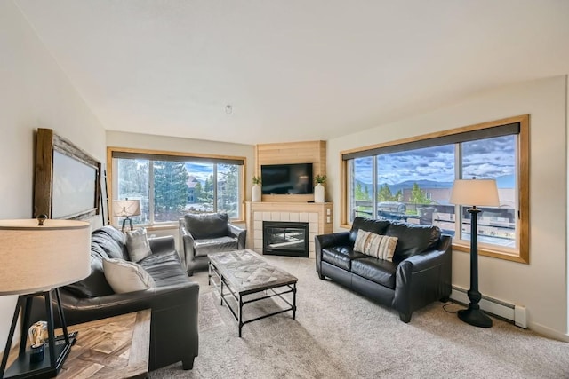 carpeted living room with a baseboard radiator, a fireplace, and baseboards