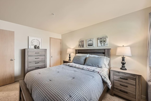 bedroom with carpet floors and baseboards