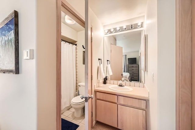 bathroom featuring toilet, vanity, and tile patterned floors