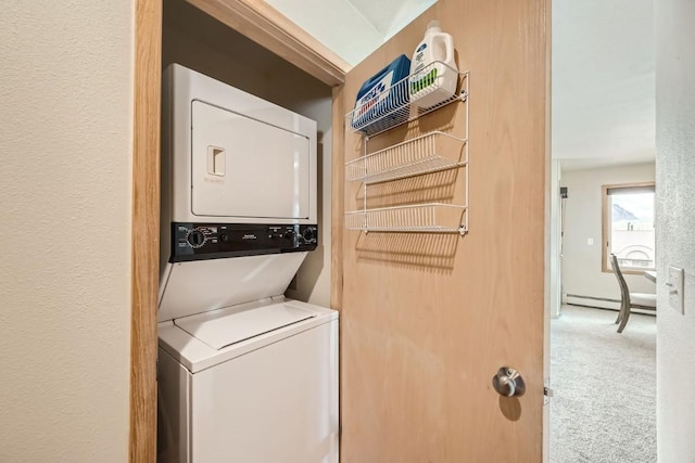 washroom featuring stacked washer and dryer, laundry area, carpet flooring, and a baseboard heating unit