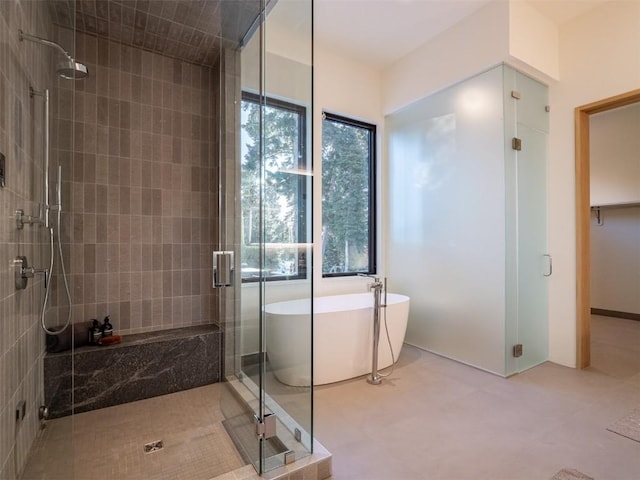 bathroom featuring shower with separate bathtub