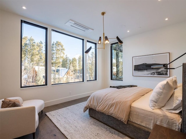 bedroom with dark hardwood / wood-style floors