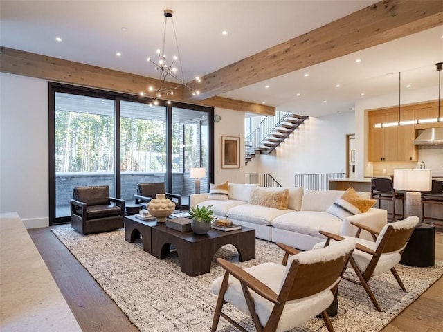 living room with beamed ceiling, dark wood-type flooring, and a notable chandelier