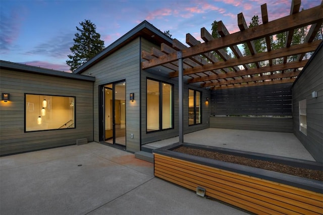 patio terrace at dusk with a pergola