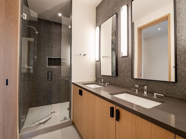 bathroom featuring tile patterned floors, vanity, and an enclosed shower