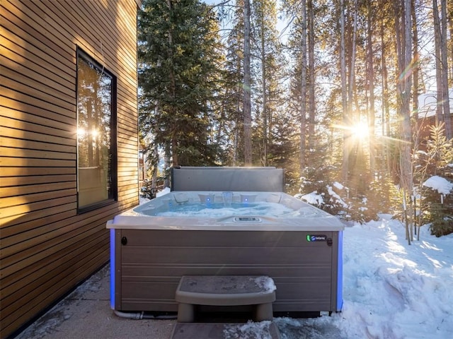 snow covered patio with a hot tub