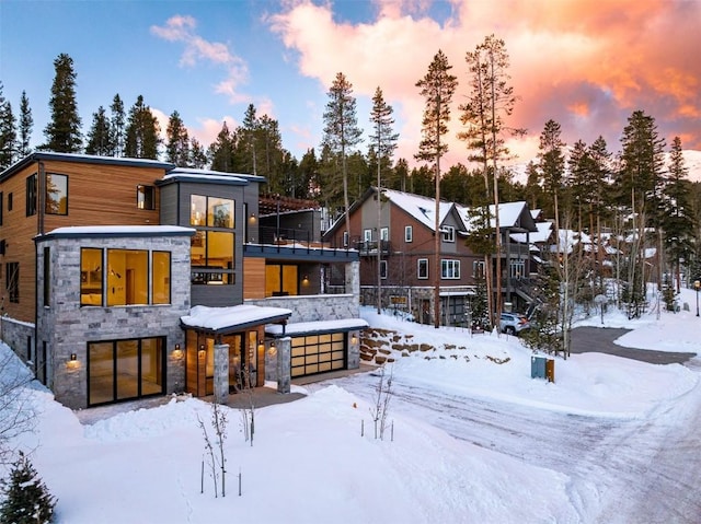 view of snow covered back of property