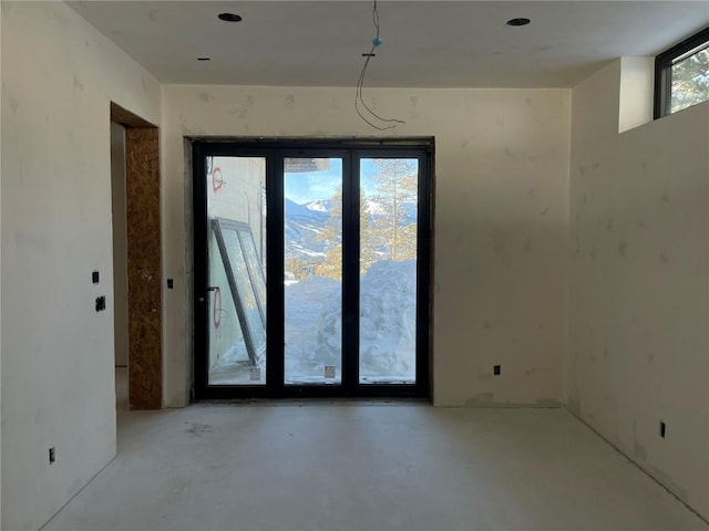 unfurnished room featuring concrete flooring