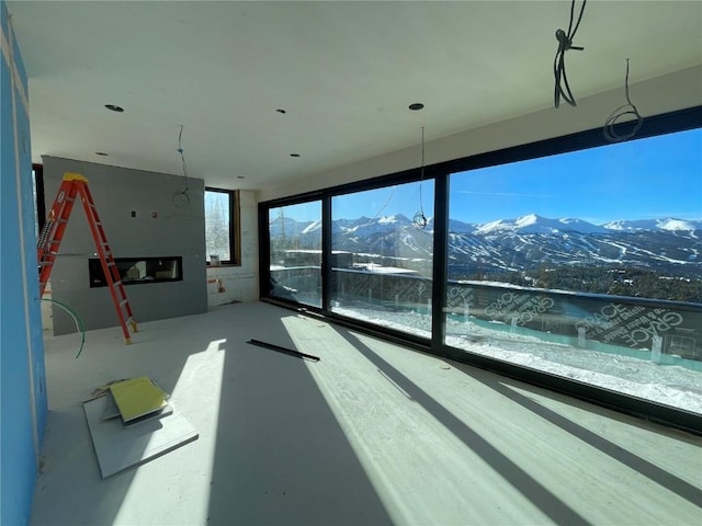 interior space with a mountain view and concrete flooring