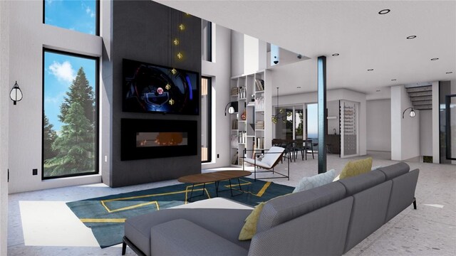 living room featuring a fireplace, a high ceiling, and recessed lighting