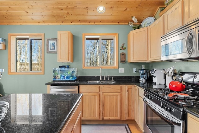 kitchen with appliances with stainless steel finishes, wood ceiling, dark stone counters, and sink