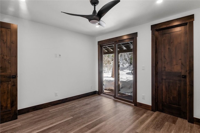 spare room featuring hardwood / wood-style flooring and ceiling fan