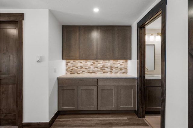 bathroom featuring hardwood / wood-style flooring, vanity, and backsplash