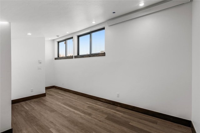 empty room with hardwood / wood-style flooring