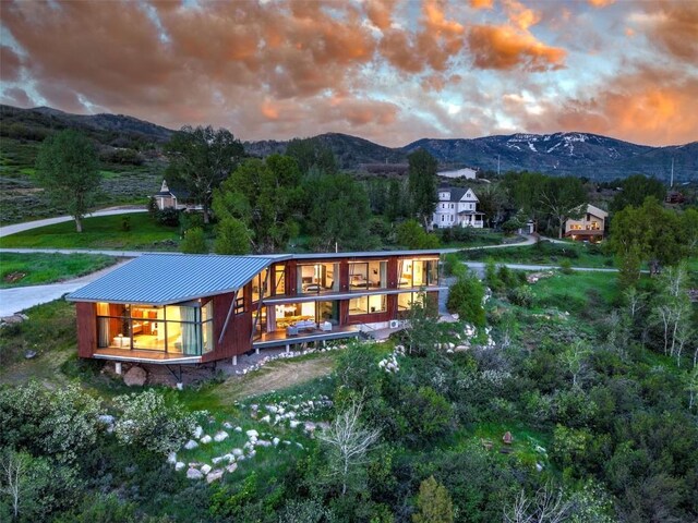 back house at dusk featuring a mountain view