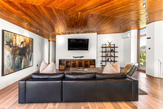 living room featuring wood ceiling, rail lighting, hardwood / wood-style floors, and an AC wall unit