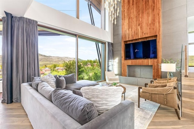 living room with light hardwood / wood-style flooring and a high ceiling