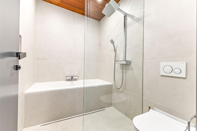 bathroom featuring tile patterned floors, toilet, wood ceiling, tile walls, and a tile shower