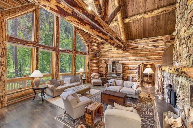 living room with a fireplace, hardwood / wood-style floors, log walls, and high vaulted ceiling