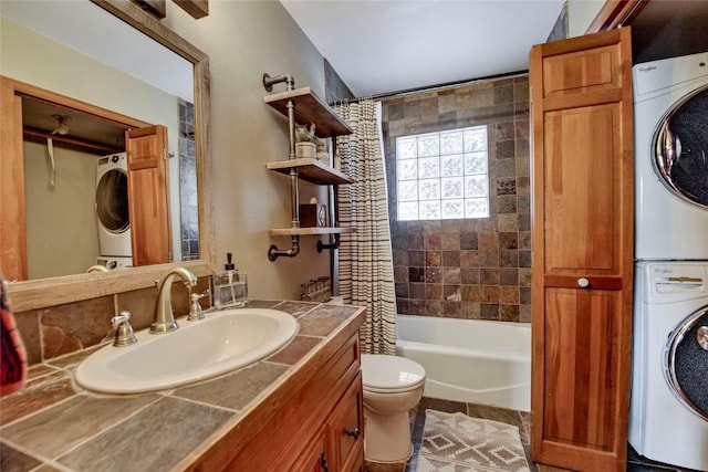 full bathroom featuring shower / tub combo with curtain, stacked washer / dryer, toilet, and vanity