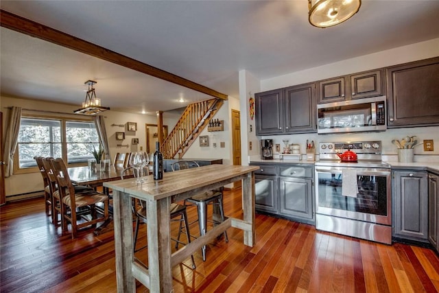 kitchen featuring dark hardwood / wood-style flooring, dark brown cabinets, stainless steel appliances, and a baseboard radiator