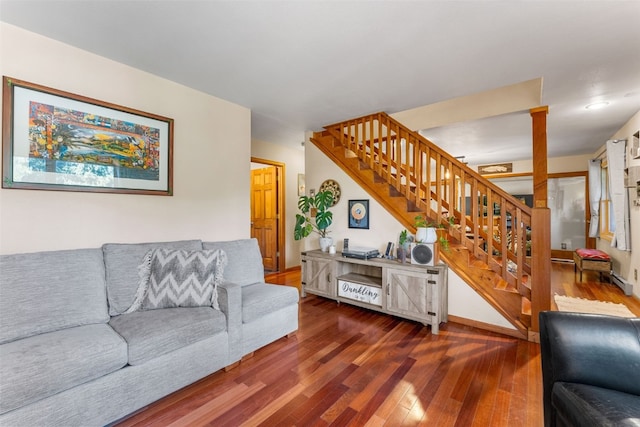 living room with wood-type flooring and decorative columns