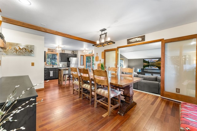 dining room with hardwood / wood-style flooring and a notable chandelier