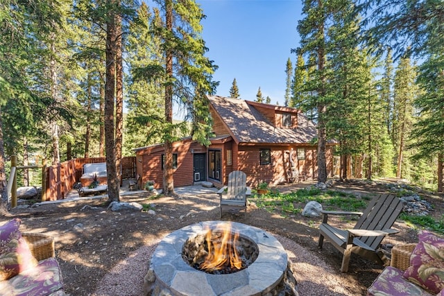 back of house featuring a patio and a fire pit