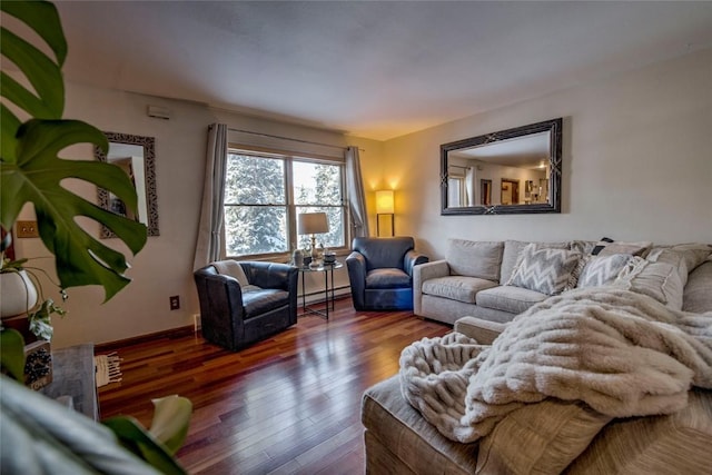 living room with baseboard heating and wood-type flooring