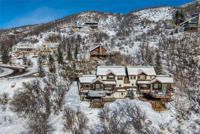 snowy aerial view featuring a mountain view