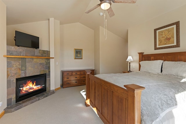 carpeted bedroom with ceiling fan, lofted ceiling, and a fireplace