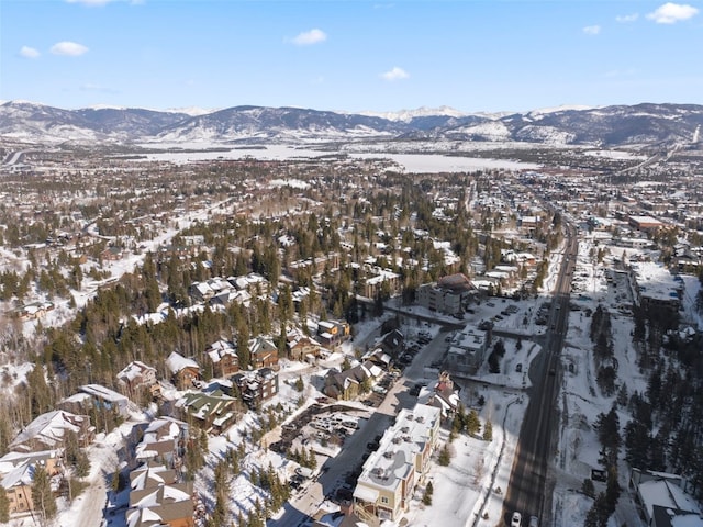 snowy aerial view with a mountain view