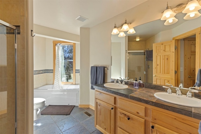 full bathroom featuring vanity, toilet, and separate shower and tub