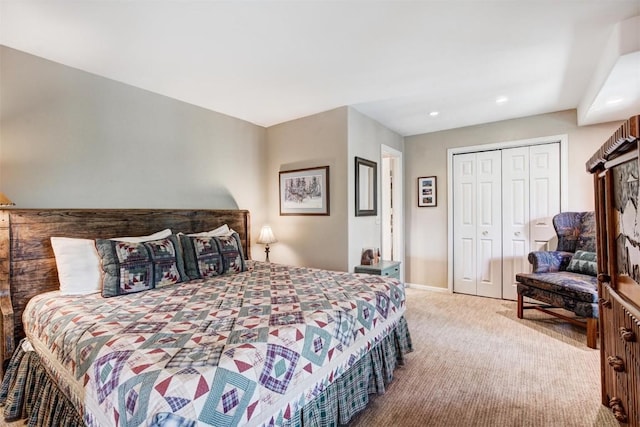 bedroom with light carpet and a closet