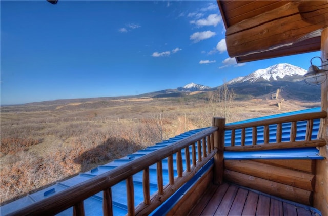 wooden deck with a mountain view