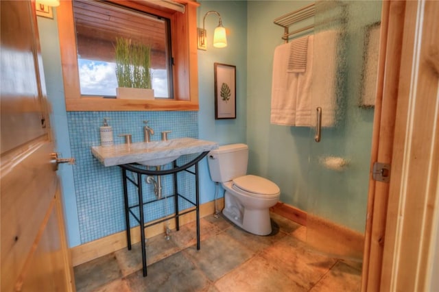 bathroom with backsplash and toilet