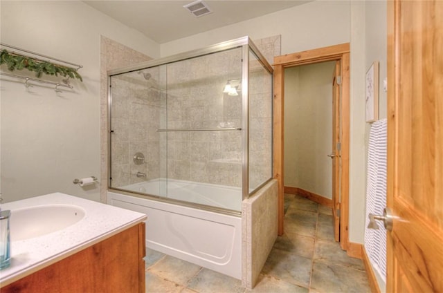 bathroom with shower / bath combination with glass door and vanity