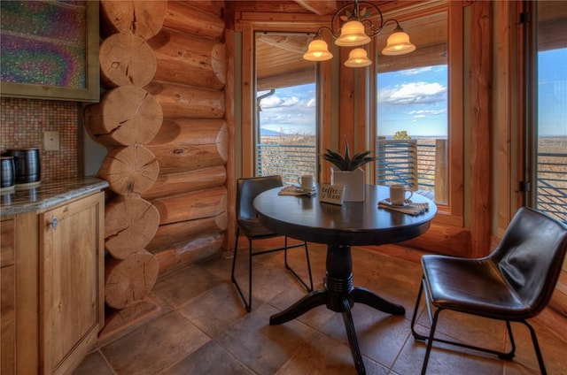 dining room featuring rustic walls and a notable chandelier