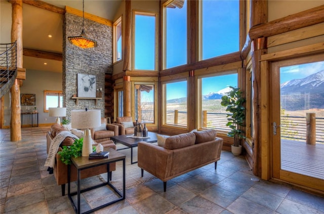 living room featuring a mountain view and a towering ceiling